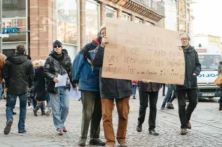 STRASBOURG, FRANCE - FEB 6, 2016: Protesters marching during a demonstration in city center against government's plan to extent the 'state of emergency' and for opened bordersのeditorial素材