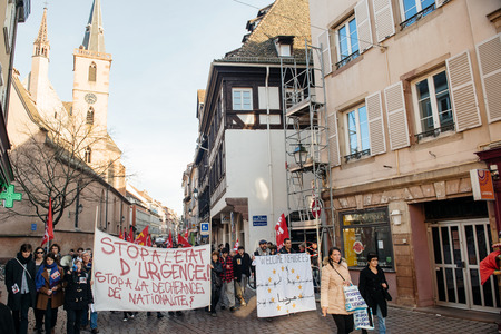 STRASBOURG, FRANCE - FEB 6, 2016: Protesters marching during a demonstration in the city center against government's plan to extent the 'state of emergency' and for opened bordersのeditorial素材