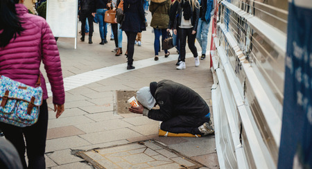 STRASBOURG, FRANCE - FEB 6, 2016: Beggar in the street of the European Capital - Strasbourg, Alsace, France