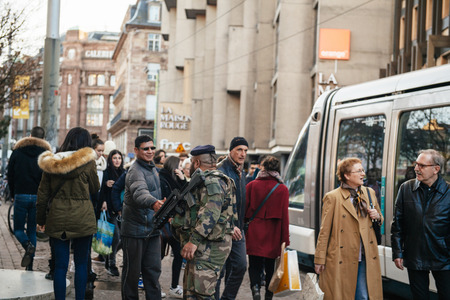 STRASBOURG, FRANCE - FEB 6, 2016: Man shaking hands of solider who patrols the city of Strasbourg during the state of emergencyのeditorial素材