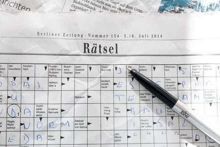 FRANKFURT, GERMANY - OCT 18, 2014: German crossword game in the Berliner Zeitung newspapper with ballpoint penのeditorial素材