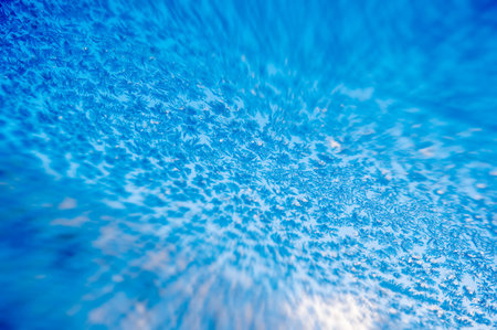 Car windshield with closeup of frozen crystals - tilt-shift effect