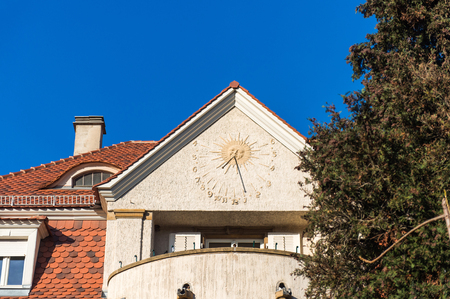 Astronomical clock in on the facade of a house on a clear sky dayの写真素材