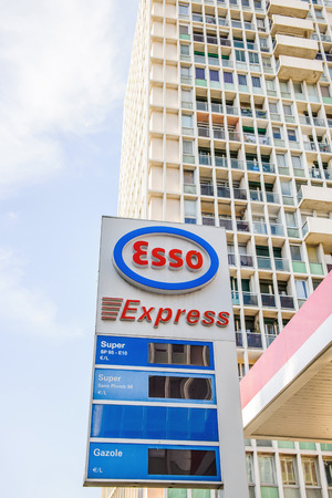 MARSEILLE, FRANCE - JUL 18, 2014: Esso Express petrol fuel station with large appartment building behind. Esso is an American brand that is the American trade name for ExxonMobil and its related companies.のeditorial素材