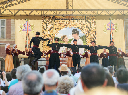 BRASOV, ROMANIA - JUL 5, 2015: Group of Georgian dancers dancing a folklore dance show on stage of a public concert in the main square of Brasovのeditorial素材