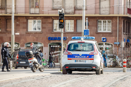 STRASBOURG, FRANCE - 9 MAR 2016: French police blocking and surveilling street as thousands of people demonstrate as part of nationwide day of protest against proposed labor reforms by Socialist Governmentのeditorial素材