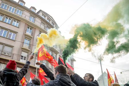 STRASBOURG, FRANCE - 9 MAR 2016: People burn flares and smokes grenade as thousands of people demonstrate as part of nationwide day of protest against proposed labor reforms by Socialist Governmentのeditorial素材