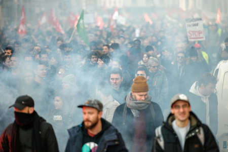 STRASBOURG, FRANCE - 9 MAR 2016: Smoke grenades in city center as thousands of people demonstrate as part of nationwide day of protest against proposed labor reforms by Socialist Governmentのeditorial素材