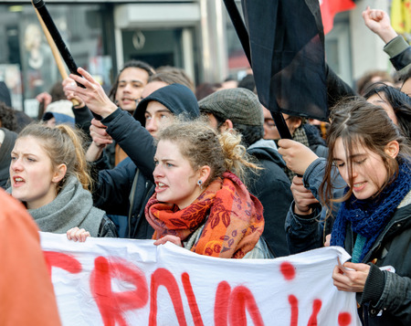 STRASBOURG, FRANCE - 9 MAR 2016: Thousands of people protesting in the center of Strasbourg with flags and smoke grenades as part of nationwide  protests against proposed labor reforms by Socialist Governmentのeditorial素材