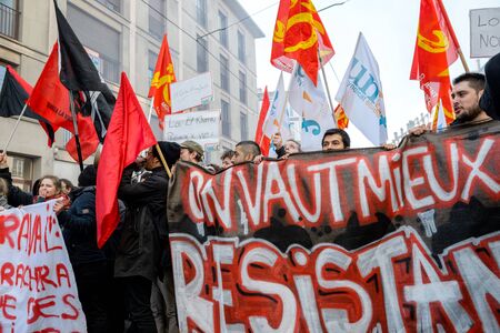 STRASBOURG, FRANCE - 9 MAR 2016: Thousands of people protesting in the center of Strasbourg with flags and smoke grenades as part of nationwide  protests against proposed labor reforms by Socialist Governmentのeditorial素材