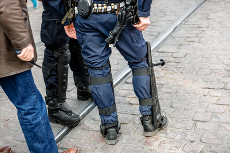 STRASBOURG, FRANCE - 9 MAR 2016: Rear view of police officer as thousands of people demonstrate as part of nationwide day of protest against proposed labor reforms by Socialist Governmentのeditorial素材