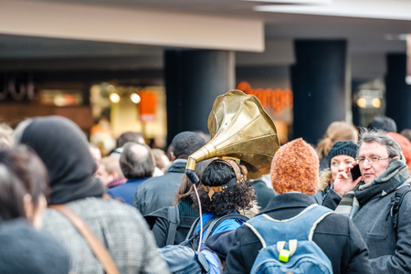STRASBOURG, FRANCE - 9 MAR 2016: Woman wearing megaphone on head as thousands of people demonstrate as part of nationwide day of protest against proposed labor reforms by Socialist Governmentのeditorial素材
