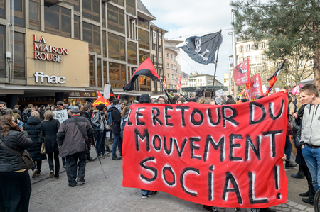 STRASBOURG, FRANCE - 9 MAR 2016: The return of social movement banner hold by people as thousands of people demonstrate as part of nationwide day of protest against proposed labor reforms by Socialist Governmentのeditorial素材