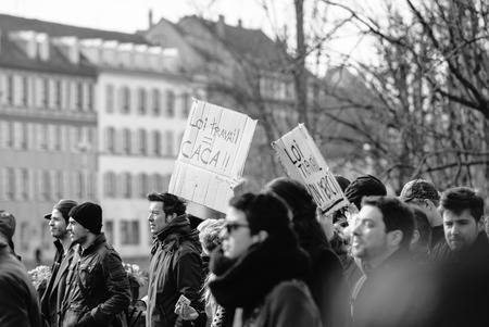STRASBOURG, FRANCE - 9 MAR 2016: New working law is shit palcard as thousands of people demonstrate as part of nationwide day of protest against proposed labor reforms by Socialist Governmentのeditorial素材