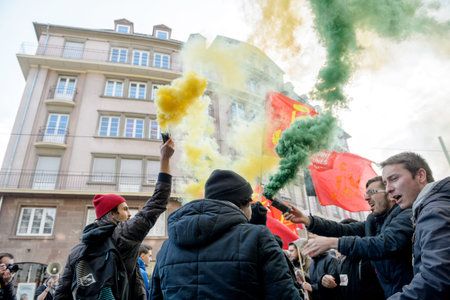 STRASBOURG, FRANCE - 9 MAR 2016: People burn flares and smokes grenade as thousands of people...