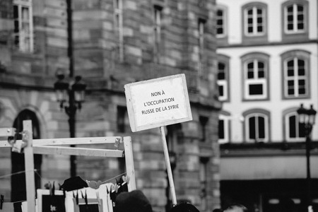 STRASBOURG, FRANCE - MAR 19, 2016: No to russian occupation placard as Syrian diaspora protests in center of Strasbourg to denouncing the Syrian attacks and show solidarity with the Syrian peopleのeditorial素材
