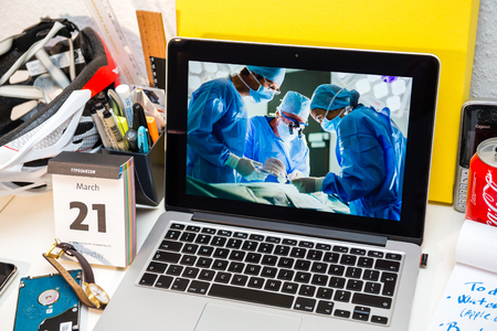 PARIS, FRANCE - MARCH 21, 2016: Apple Computers website on MacBook Pro Retina in a creative room environment showcasing Apple Event with Apple COO Jeff Williams and Care Kit presentation in hospital environmentのeditorial素材