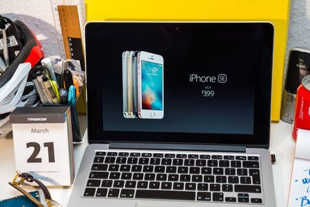 PARIS, FRANCE - MARCH 21, 2016: Apple Computers website on MacBook Pro Retina in a creative room environment showcasing Apple Event with Greg Joswiak presenting new iPhone se and 399 priceのeditorial素材