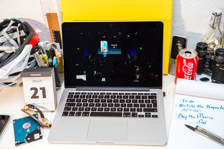 PARIS, FRANCE - MARCH 21, 2016: Apple Computers website on MacBook Pro Retina in a creative room environment showcasing Apple Event with Greg Joswiak presenting iPhone SEのeditorial素材