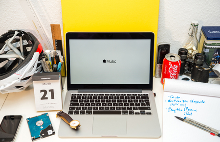 PARIS, FRANCE - MARCH 21, 2016: Apple Computers website on MacBook Pro Retina in a creative room environment showcasing Apple Event with Apple Music logoのeditorial素材