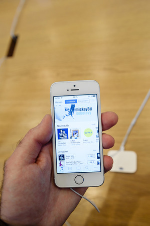 PARIS, FRANCE - APR 4, 2016: Apple music app on the new Apple iPhone SE during the sales launch of the latest Apple Inc. smartphone and iPad Pro at the Apple store in Paris, Franceのeditorial素材