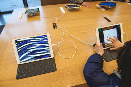 PARIS, FRANCE - APR 4, 2016: Kid playing game on the new 9.7-inch iPad Pro during the sales launch...