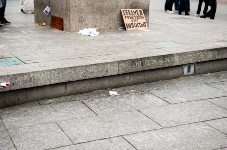 STRASBOURG, FRANCE - APR 9, 2016: French placard on General Kleber statue reading "Waking up for 1200 Euro is insulting" during public placard drawings in Place Kleberのeditorial素材