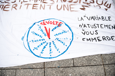 STRASBOURG, FRANCE - APR 9, 2016: French placard reading with clock face reading "Revolution" during public placard drawings in Place Kleberのeditorial素材