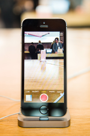 STRASBOURG, FRANCE - APR 9, 2016: New iPhone SE in docking station recording Apple Store with camera app. New Apple iPhone tends to become one of the most popular smart phones in the world.のeditorial素材