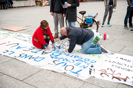 STRASBOURG, FRANCE - APR 9, 2016: People making placards during public placard drawings in Place Kleber for the upcoming protests against proposed labor reforms by Socialist Governmentのeditorial素材