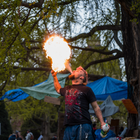STRASBOURG, FRANCE - APR 9, 2016: Fire-eater performing as people join the 'Nuit Debout' or 'Standing night' movement at the Place de la Republique in Strasbourgのeditorial素材