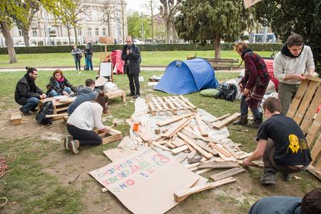 STRASBOURG, FRANCE - APR 9, 2016: People building from wood seats during 'Nuit Debout' or 'Standing night' movement at the Place de la Republique in Strasbourgのeditorial素材
