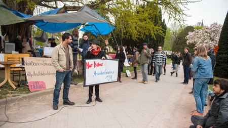 STRASBOURG, FRANCE - APR 9, 2016: Woman addressing to crowd as people join the 'Nuit Debout' or 'Standing night' movement at the Place de la Republique in Strasbourgのeditorial素材