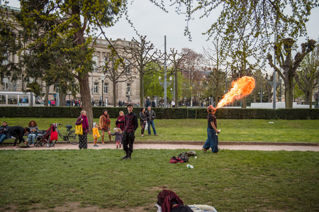STRASBOURG, FRANCE - APR 9, 2016: Fire-eater performing as people join the 'Nuit Debout' or 'Standing night' movement at the Place de la Republique in Strasbourgのeditorial素材