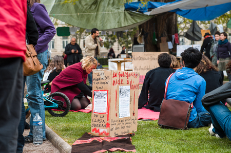STRASBOURG, FRANCE - APR 9, 2016: Solidarity helps to win box with people join the 'Nuit Debout' or 'Standing night' movement at the Place de la Republique in Strasbourgのeditorial素材