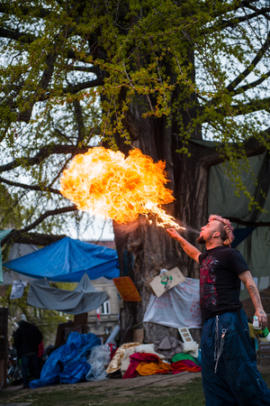 STRASBOURG, FRANCE - APR 9, 2016: Fire-eater performing as people join the 'Nuit Debout' or 'Standing night' movement at the Place de la Republique in Strasbourgのeditorial素材