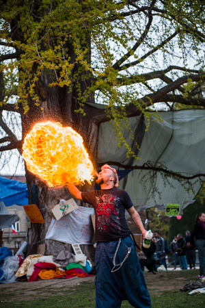 STRASBOURG, FRANCE - APR 9, 2016: Fire-eater performing as people join the 'Nuit Debout' or 'Standing night' movement at the Place de la Republique in Strasbourgのeditorial素材