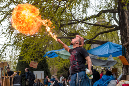 STRASBOURG, FRANCE - APR 9, 2016: Fire-eater performing as people join the 'Nuit Debout' or 'Standing night' movement at the Place de la Republique in Strasbourgのeditorial素材