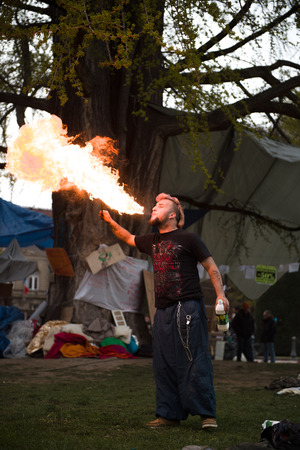 STRASBOURG, FRANCE - APR 9, 2016: Fire-eater performing as people join the 'Nuit Debout' or 'Standing night' movement at the Place de la Republique in Strasbourgのeditorial素材