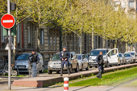 STRASBOURG, FRANCE - APR 20, 2016: Armed police offiers protectin street  as hundreds of people demonstrate as part of nationwide day of protest against proposed labor reforms by Socialist Governmentのeditorial素材
