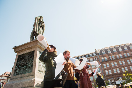 STRASBOURG, FRANCE - APR 20, 2016: Woman speaking in improvised megaphone as hundreds of people demonstrate as part of nationwide day of protest against proposed labor reforms by Socialist Governmentのeditorial素材