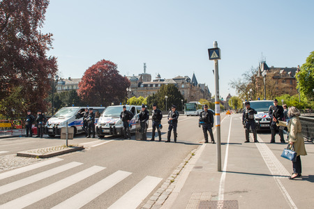 STRASBOURG, FRANCE - APR 20, 2016: Police blocking street as hundreds of people demonstrate as part of nationwide day of protest against proposed labor reforms by Socialist Governmentのeditorial素材