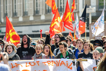 STRASBOURG, FRANCE - APR 20, 2016: Crowd yelling as hundreds of people demonstrate as part of nationwide day of protest against proposed labor reforms by Socialist Governmentのeditorial素材