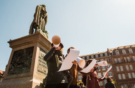 STRASBOURG, FRANCE - APR 20, 2016: Woman speaking in improvised megaphone as hundreds of people demonstrate as part of nationwide day of protest against proposed labor reforms by Socialist Governmentのeditorial素材