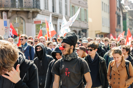 STRASBOURG, FRANCE - APR 20, 2016: Man wearing clown nose as hundreds of people demonstrate as part of nationwide day of protest against proposed labor reforms by Socialist Governmentのeditorial素材
