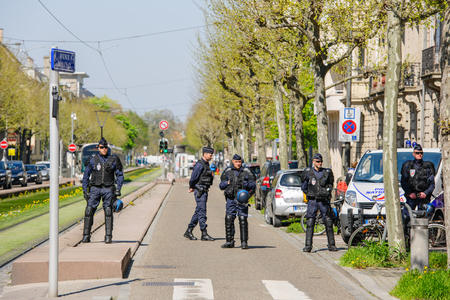 STRASBOURG, FRANCE - APR 20, 2016: Armed police offiers protectin street  as hundreds of people demonstrate as part of nationwide day of protest against proposed labor reforms by Socialist Governmentのeditorial素材