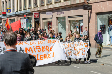 STRASBOURG, FRANCE - APR 20, 2016: Man looking at protest as hundreds of people demonstrate as part of nationwide day of protest against proposed labor reforms by Socialist Governmentのeditorial素材
