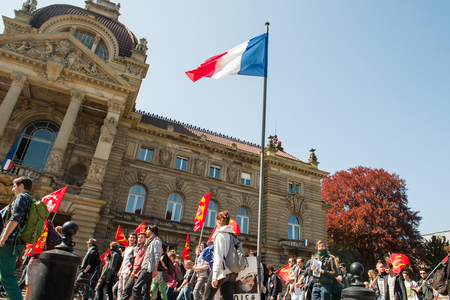 STRASBOURG, FRANCE - APR 20, 2016: Place de la republique with Palais du Rihn in the background and hundreds of people demonstrate as part of nationwide day of protest against proposed labor reforms by Socialist Governmentのeditorial素材
