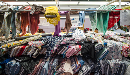STRASBOURG, FRANCE - APR 24, 2016: Overview of textile fabric at traditional textile covered market with multiple different colors and texturesのeditorial素材