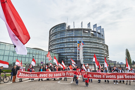 STRASBOURG, FRANCE - APR 30, 2016: Main entrance at European Parliament with crowd protesting against government regional reform for the fusion of the Alsace region with Lorraine and Champagne-Ardenneのeditorial素材